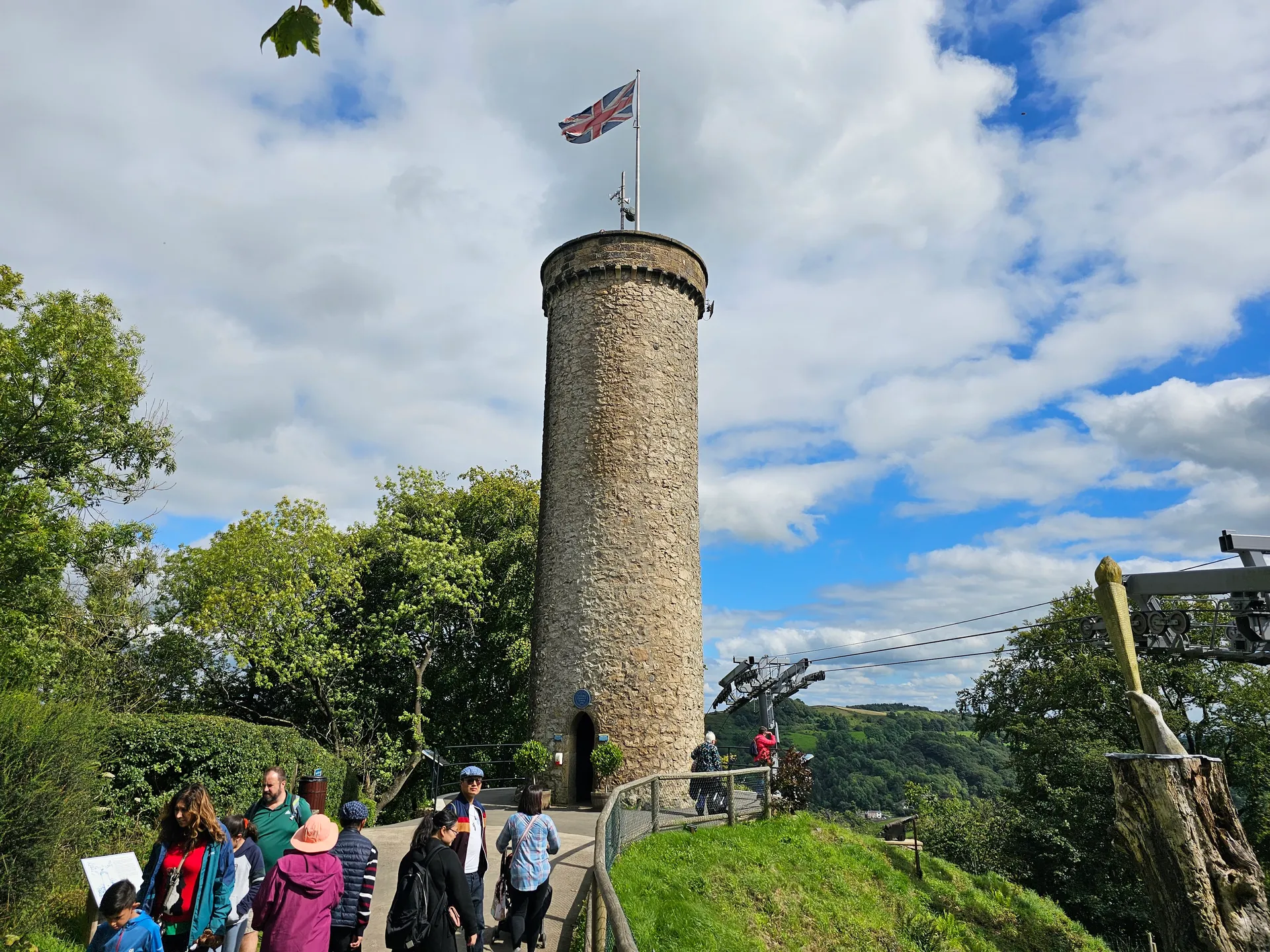 Victoria Prospect Tower at the Heights of Abraham with a Union Jack flag and visitors on a sunny day.